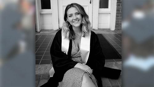 Senior Caitlyn Deal sits on the steps of historic Smith Hall