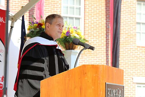 Police Chief Lou Dekmar stands at the podium on Commencement morning speaking to 2019 graduates