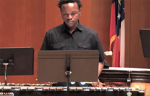 Student plays the marimba during a special holiday performance