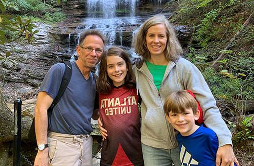 Dr. Baxter's family in front of a waterfall