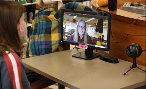 Librarian Amber Spratlin works with a student via computer