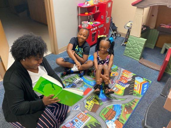 Kiara Tookes-Williams reads a story to a staff member's children