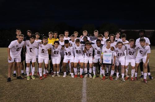 Men's soccer team poses for a group photo after the championship game