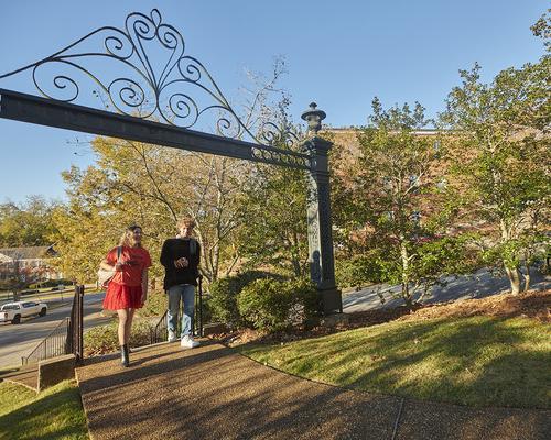 Students walking past the arch